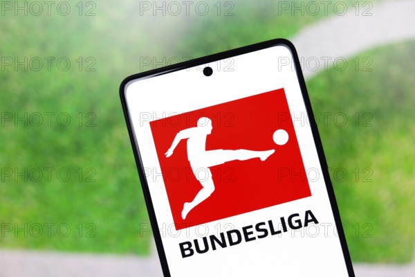 In this photo illustration, the Bundesliga logo is displayed on a smartphone screen