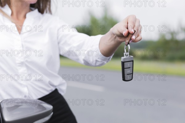 Close up woman holding car keys