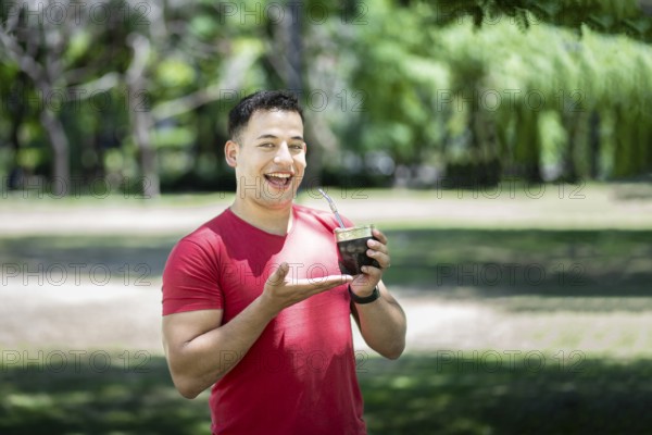 Happy latin man showing his mate tea