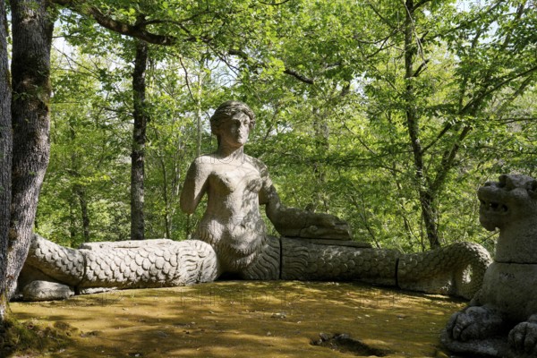 Siren and two lions, Sacro Bosco, Sacred Forest, Park of the Monsters, Parco dei Mostri, grotesque, monumental sculptures, antique architecture, city of Bomarzo, province of Viterbo, Lazio region, Italy, Bomarzo, Lazio, Italy, Europe
