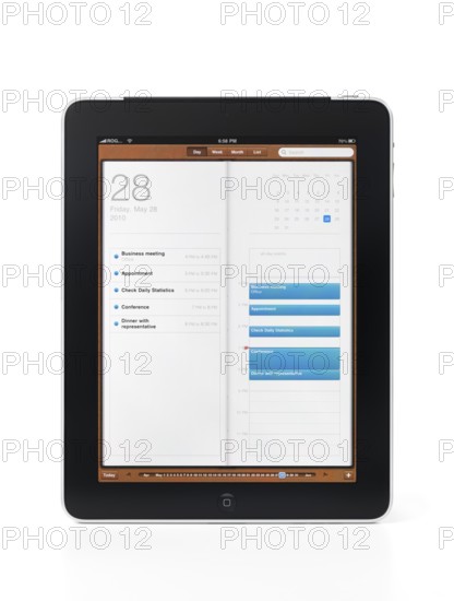 Apple iPad 3G tablet with organizer calendar app showing a list of business events and appointments on its display. Isolated on white background with clipping path.