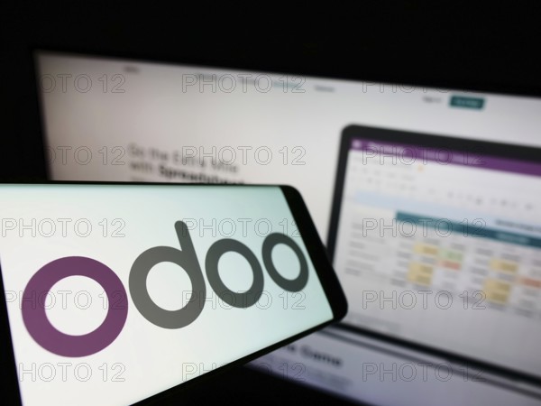 Stuttgart, Germany, 03-29-2022: Cellphone with logo of French software company Odoo SA on screen in front of business website. Focus on left of phone display, Europe