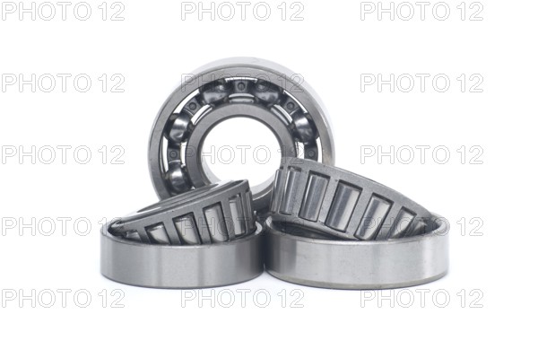 Single row tapered roller bearings and deep groove ball bearing without seal isolated on white background. Spare parts for machinery and automotive industry