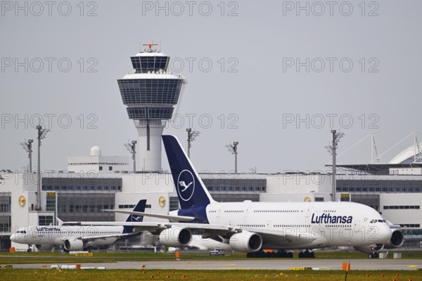 Lufthansa Airbus A380-800 with control tower, taxiing in front of Terminal 2 to runway South Terminal 2, Munich Airport, Upper Bavaria, Bavaria, Germany, Europe