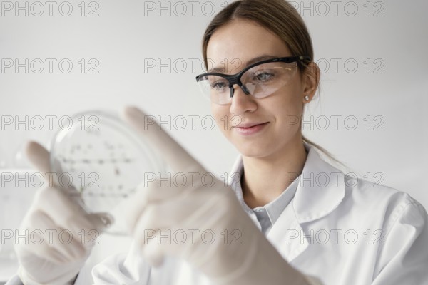 Medium shot scientist holding petri dish
