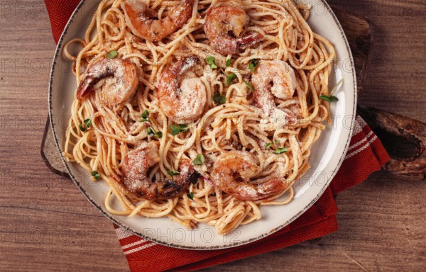 Spaghetti with tiger prawns, in tomato sauce, homemade, top view, no people