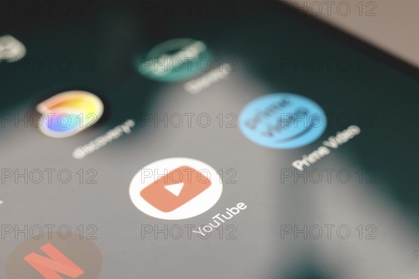 In this photo illustration, the app logo Netflix, YouTube and Prime Video is displayed on a smartphone screen