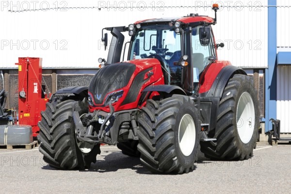Red Valtra T235 tractor parked outside at the AGCO agricultural machinery dealership. Salo, Finland. June 22, 2024