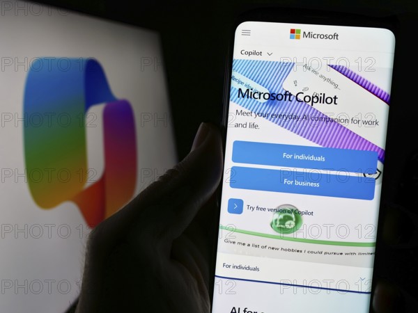 Stuttgart, Germany, 02-22-2024: Person holding cellphone with webpage of artificial intelligence chatbot Microsoft Copilot in front of logo. Focus on center of phone display, Europe