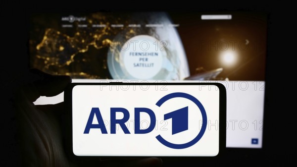 Stuttgart, Germany, 04-10-2024: Person holding cellphone with logo of German public-service broadcasting organisation ARD in front of webpage. Focus on phone display, Europe