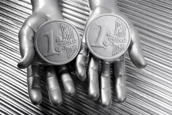Two silver euro coins in futuristic robot gray metallic hands bank metaphor