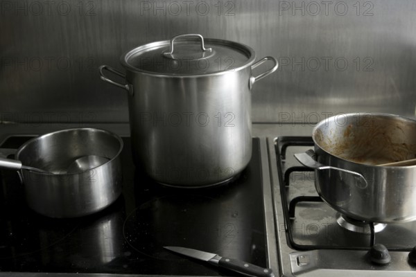 Dirty used stainless steel kitchen cooking stuff, pans