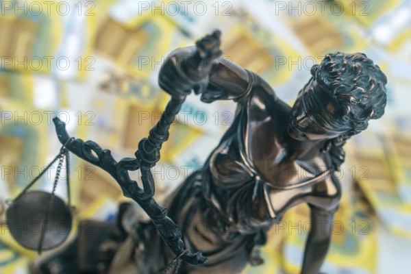 Justitia Figure with 200 euro bills in the Background. Concept justice and money