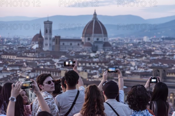FLORENCE, ITALY, SEPTEMBER 21, 2023, Large tourist crowd on Piazzale Michelangelo enjoying sunset over Florence, Italy, Europe
