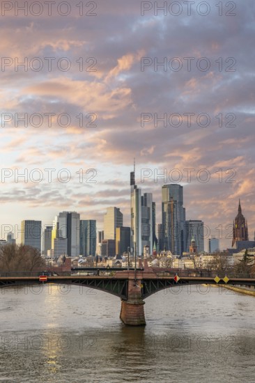A big city in the evening at sunset. Modern buildings in a skyline by the river. Skyscrapers are reflected in the water. Modern architecture of the metropolis Frankfurt am Main, Germany, Europe