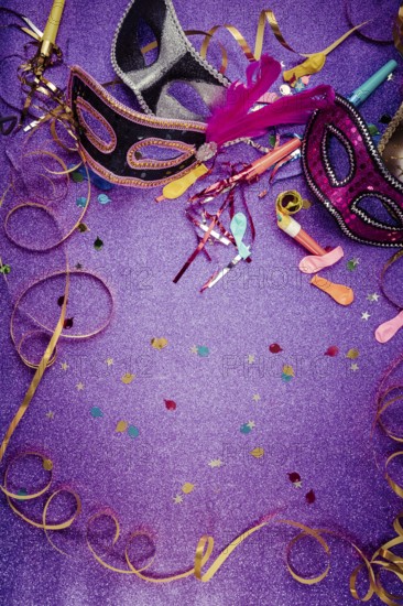 Carnival Mask, Streamers And Confetti For Festive Background in violet tone with copy space
