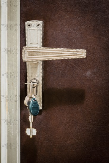Home door. Keys are inserted in the lock of the entrance door of the apartment