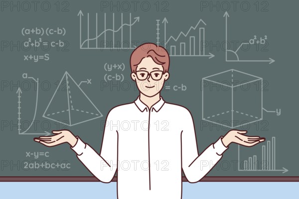 Man mathematics teacher stands near school blackboard with formulas and geometric drawings. Young smart professor in white shirt and glasses works at university studying science of mathematics
