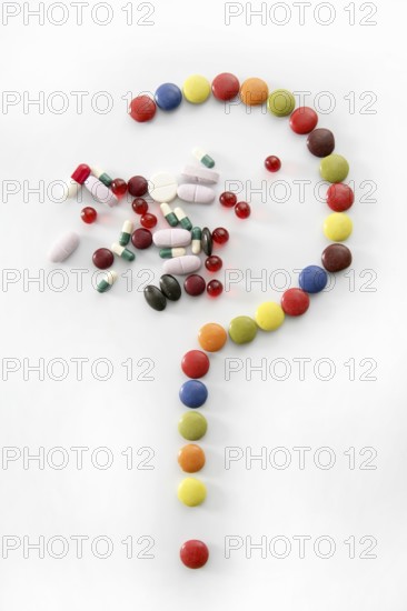 Candy sweets question mark isolated over white background and pills