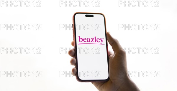 Beazley logo is displayed on smartphone. Beazley plc is the British parent company of specialist insurance businesses with operations in Europe.