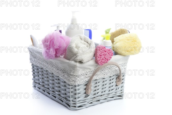 Bath toiletries basket with shower gel shampoo sponge and towel