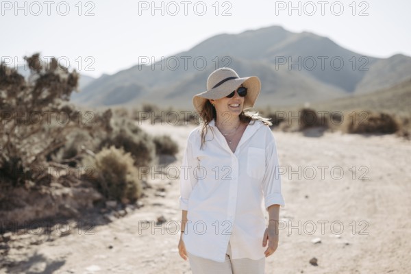 Woman with sunglasses and sun hat on a gravel road, South Africa, Africa