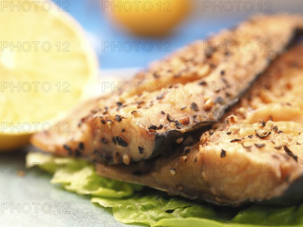 Tasty smoked mackerel garnished with pepper corns, selective focus