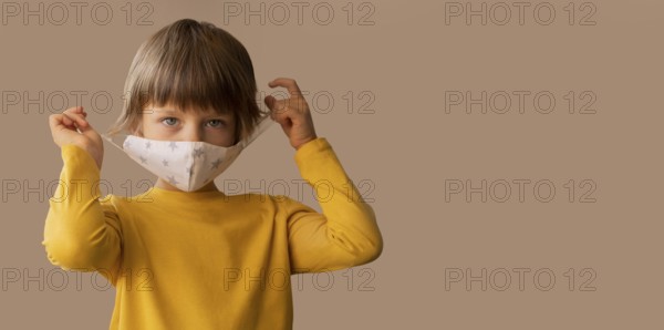 Boy wearing medical mask with copy space