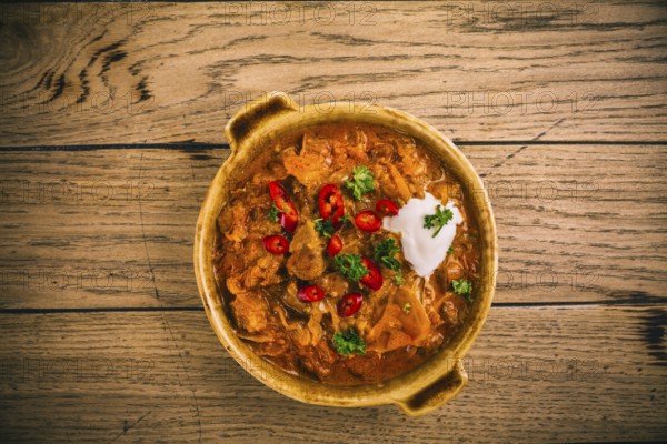 Hungarian Szegedin Goulash with pickled white cabbage (sauerkraut), onion and bread dumplings in pan