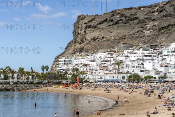 PUERTO DE MOGAN, GRAN CANARIA, CANARY ISLANDS - MARCH 7 : View of the beach in Puerto de Mogan Gran Canaria on March 7, 2022. Unidentified people