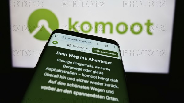 Stuttgart, Germany, 05-23-2024: Cellphone with web page of German route planning app company komoot GmbH in front of business logo. Focus on top-left of phone display, Europe