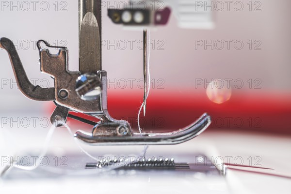 Close up of sewing metal sewing needle with sewing thread