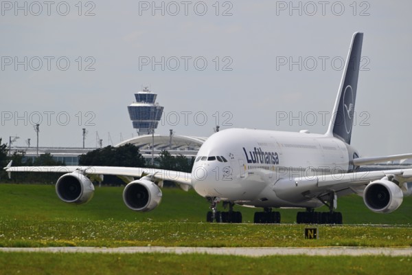 Lufthansa Airbus A380-800 with control tower taxiing from Terminal 2 to Runway North, Munich Airport, Upper Bavaria, Bavaria, Germany, Europe