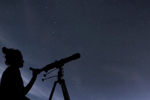 Woman with telescope watching the stars. Stargazing woman and night sky