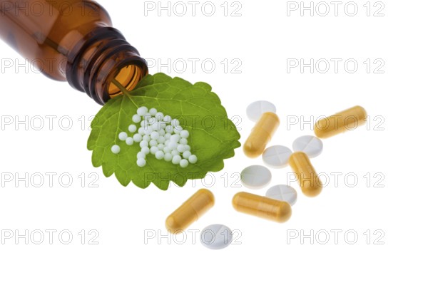 Homeopathy. Globules as an alternative medicine. Lying on a sheet, Homeopathy. Globules as alternative medicine. Lying on a leaf. Austria