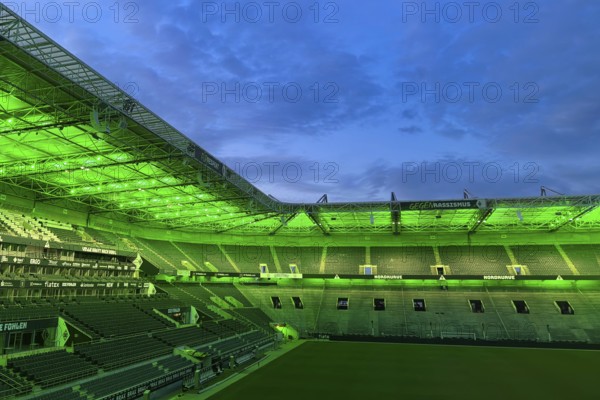 Football stadium Borussiapark without spectators, illuminated in green, sunset, Mönchengladbach, Germany, Europe
