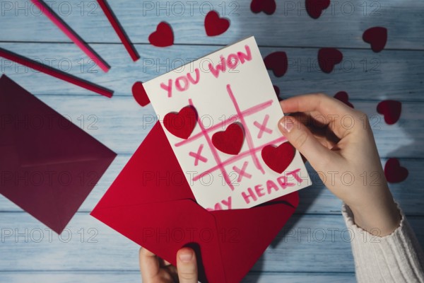 Valentines Day. Instructions for making valentine cards. Text YOU WON MY HEART and tic tac toe game Postcard craft, greeting card. DIY Step by step instruction. Making of handmade Valentine greeting card hobby concept, gift with your own hands