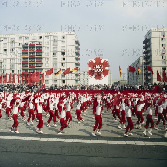 198005010101, East Berlin, 01.05.1980, Karl-Marx-Allee, sportswomen with scarves during a demonstration in front of the honour stage at the May Day demonstration East Berlin, GDR GDR