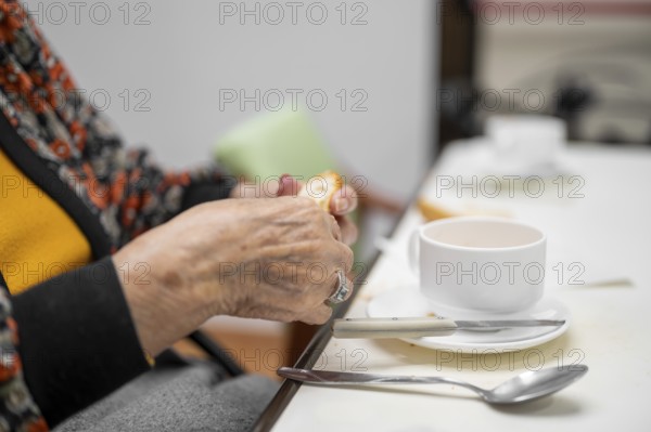 Close up of elderly woman enjoying breakfast.
