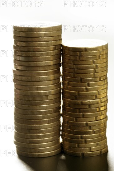 Euro coin columns, golden cash over white background at studio