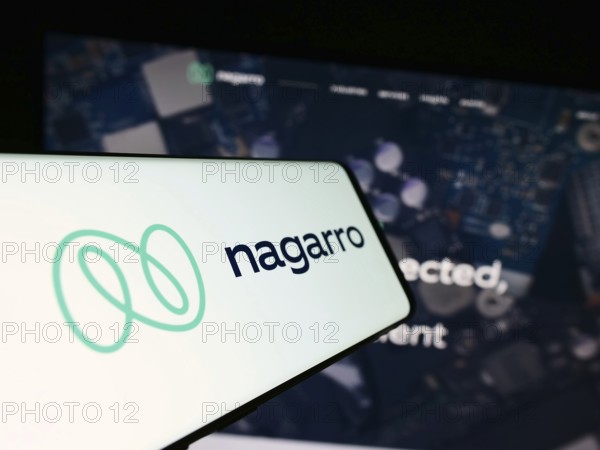 Stuttgart, Germany, 08-20-2023: Mobile phone with logo of information technology company Nagarro SE on screen in front of business website. Focus on center of phone display, Europe