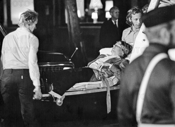 The Norrmalmstorg robbery 23-28 august 1973. Kreditbanken on Normmalmstorg in Stockholm. The first criminal event in Sweden to be covered by live television. Jan-Erik Olsson was the robber and was joined by former cellmate and friend Clark Olofsson in the bank. The robbers gave up after that the police used teargas, no one of the hostages was hurt. A bank robbery and hostage crisis best known as the origin of the term Stockholm syndrome that is a proposed condition in which hostages develop a physological bond with their captors. Picture shows hostage Sven Säfström being taken to hospital after the event was over
