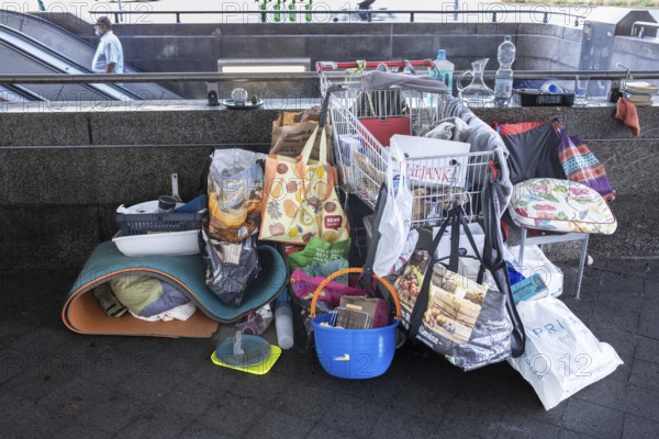Hanover - Poverty, homelessness. Belongings in plastic bags and a shopping trolley on the stairs to the underground, Hanover, Lower Saxony, Germany, Europe