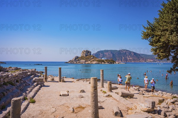 Ancient ruins on the shore with a view of the sea and a rocky island in the background, Agios Stefanos, Kos Island, Greece, Europe