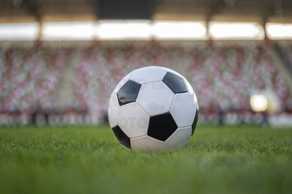 Soccer ball and legs of young player before kicking the ball