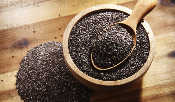 Bowl of chia seeds on wooden table