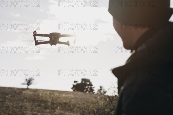 Close up man watching drone. Beautiful photo