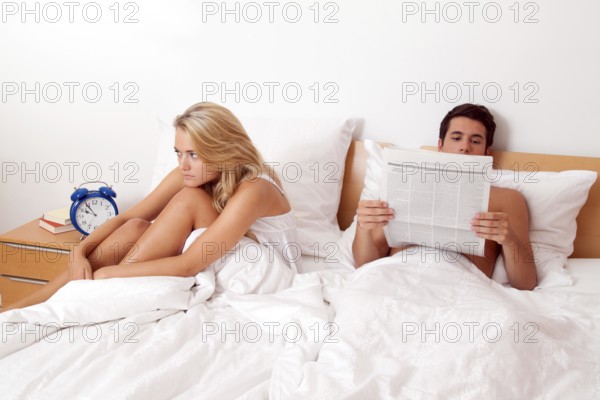 A young couple in bed having problems and crisis. Divorce and separation, A young couple in bed having problems and crisis. Divorce and separation. Austria