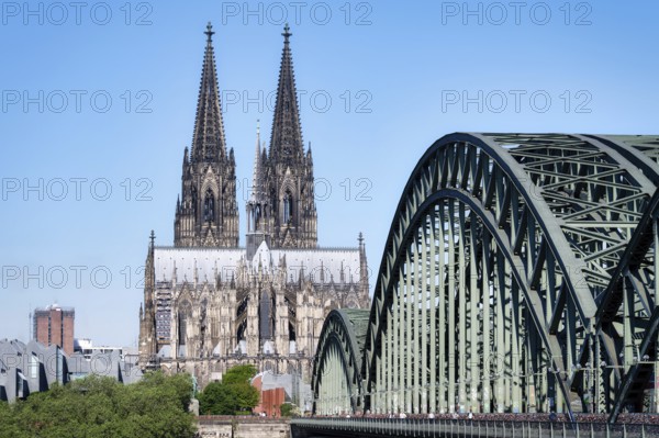 View across the Rhine along the Hohenzollern Bridge to Cologne Cathedral in the warm morning light in May 2024