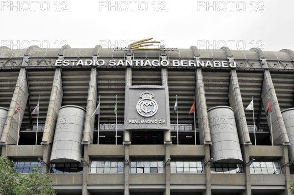 Estadio Santiago Bernabéu, football stadium of the Spanish club Real Madrid, 80354 seats, Madrid, Spain, Europe, The main facade of the Santiago Bernabéu stadium with the Real Madrid crest and several flags, Europe